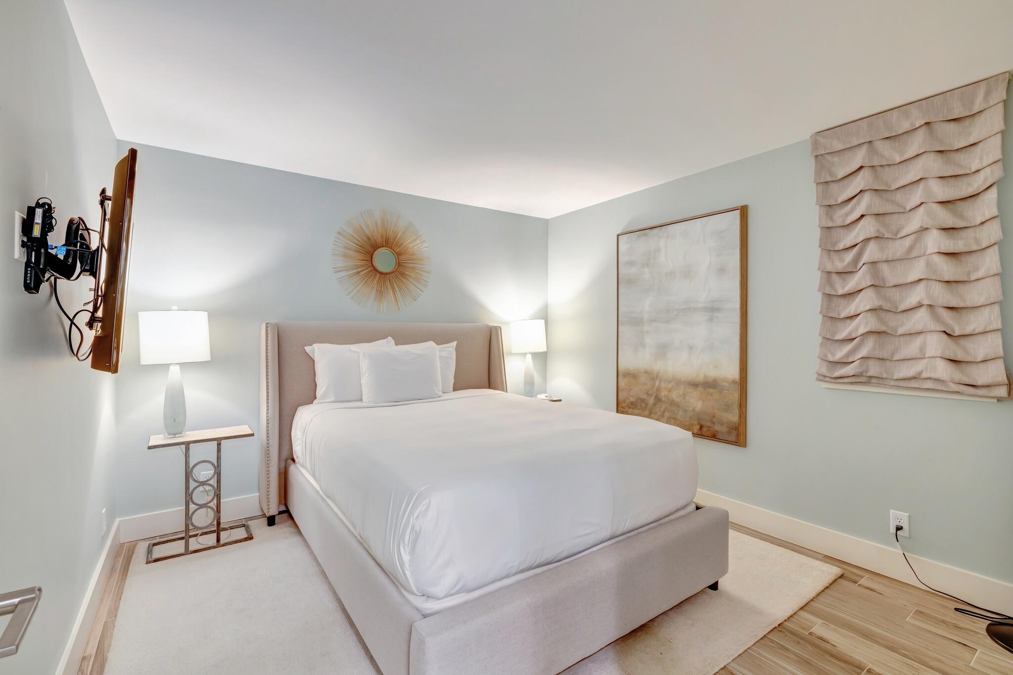 4323 Beachside 2, Unit 323 Miramar Beach, FL 32550 - Photo 23 of 41 a bedroom with a bed and a lamp with the wooden floor