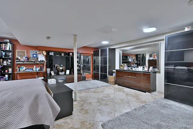 a large kitchen with stainless steel appliances kitchen island granite countertop a refrigerator a stove a sink a dining table and chairs with the view of kitchen