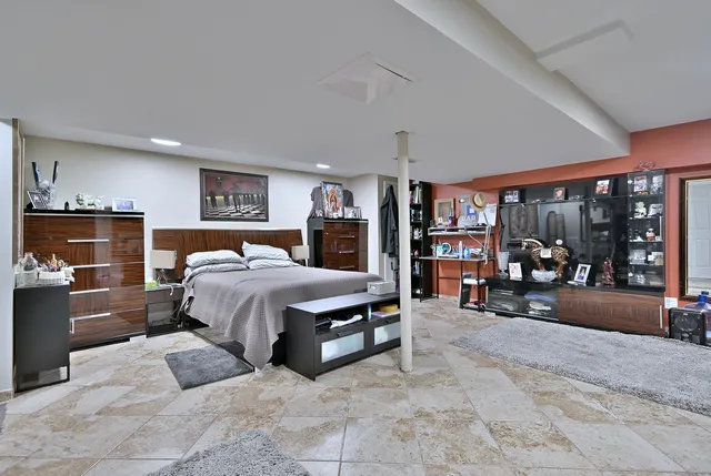 a spacious bedroom with a bed and a large window