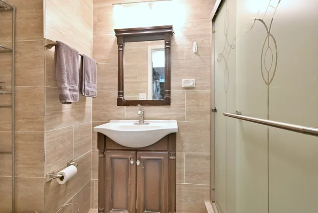 a bathroom with a sink a mirror and shower