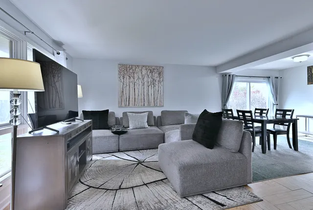 a living room with furniture a rug and a table