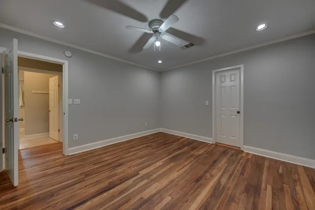a bathroom with a granite countertop sink a toilet and a mirror