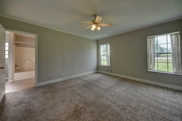 a bathroom with a granite countertop sink a mirror and a bathtub
