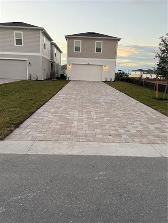a view of house with yard and garage
