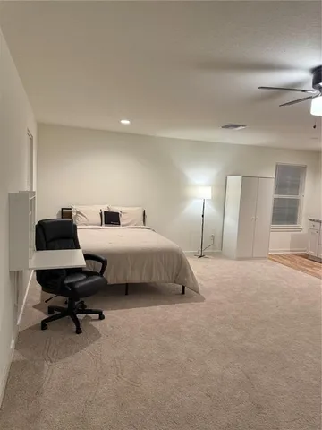 a bedroom with a bed and a chair