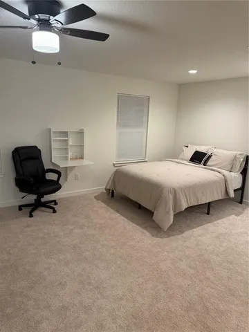 a view of a livingroom with furniture and a ceiling fan
