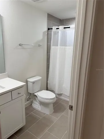 a living room with stainless steel appliances kitchen island granite countertop a sink and cabinets