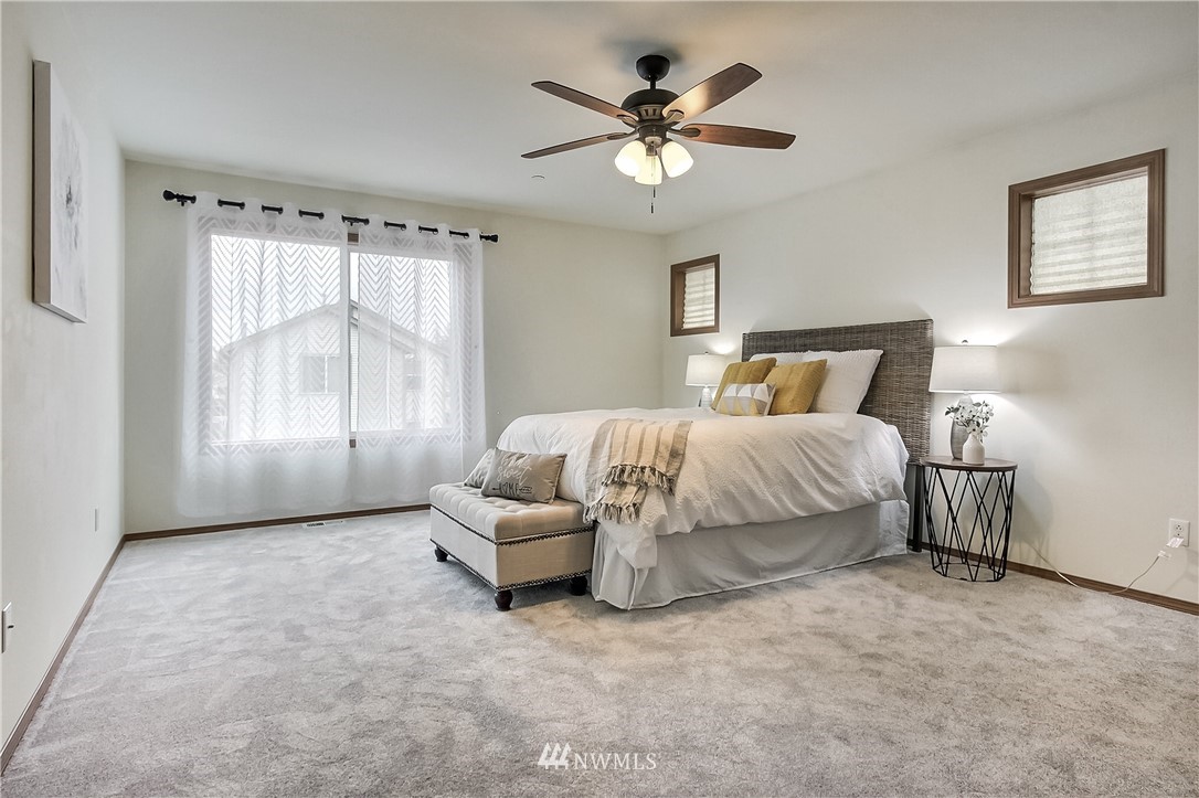 3104 Walker Road DuPont, WA 98327 - Photo 12 of 25 a spacious bedroom with a bed and a window