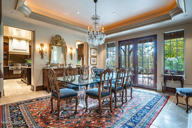 a living room with furniture a large window and a table