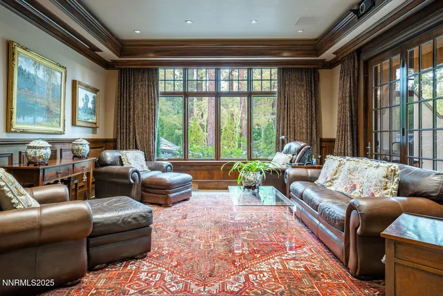a living room with furniture a rug and a bookshelf