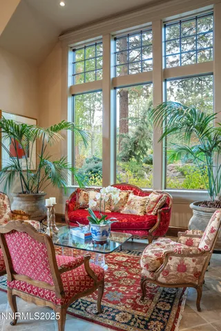 a living room with furniture a rug and a large window