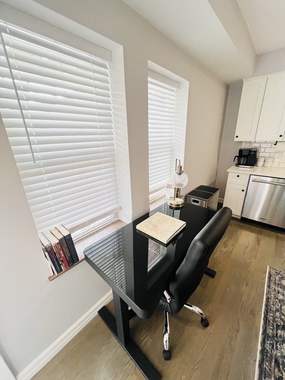 47-49 Walnut Street, Unit 1R Boston, MA 02122 - Photo 8 of 13 a view of a workspace with furniture and a window