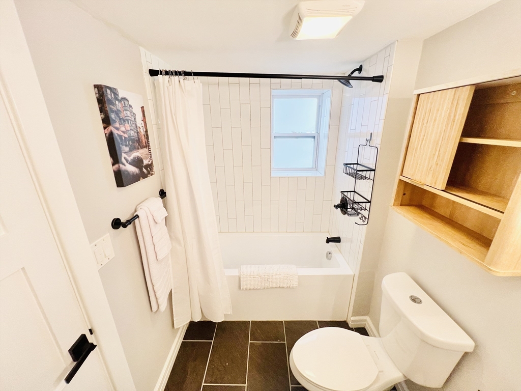47-49 Walnut Street, Unit 1R Boston, MA 02122 - Photo 10 of 13 a bathroom with a toilet and a shower