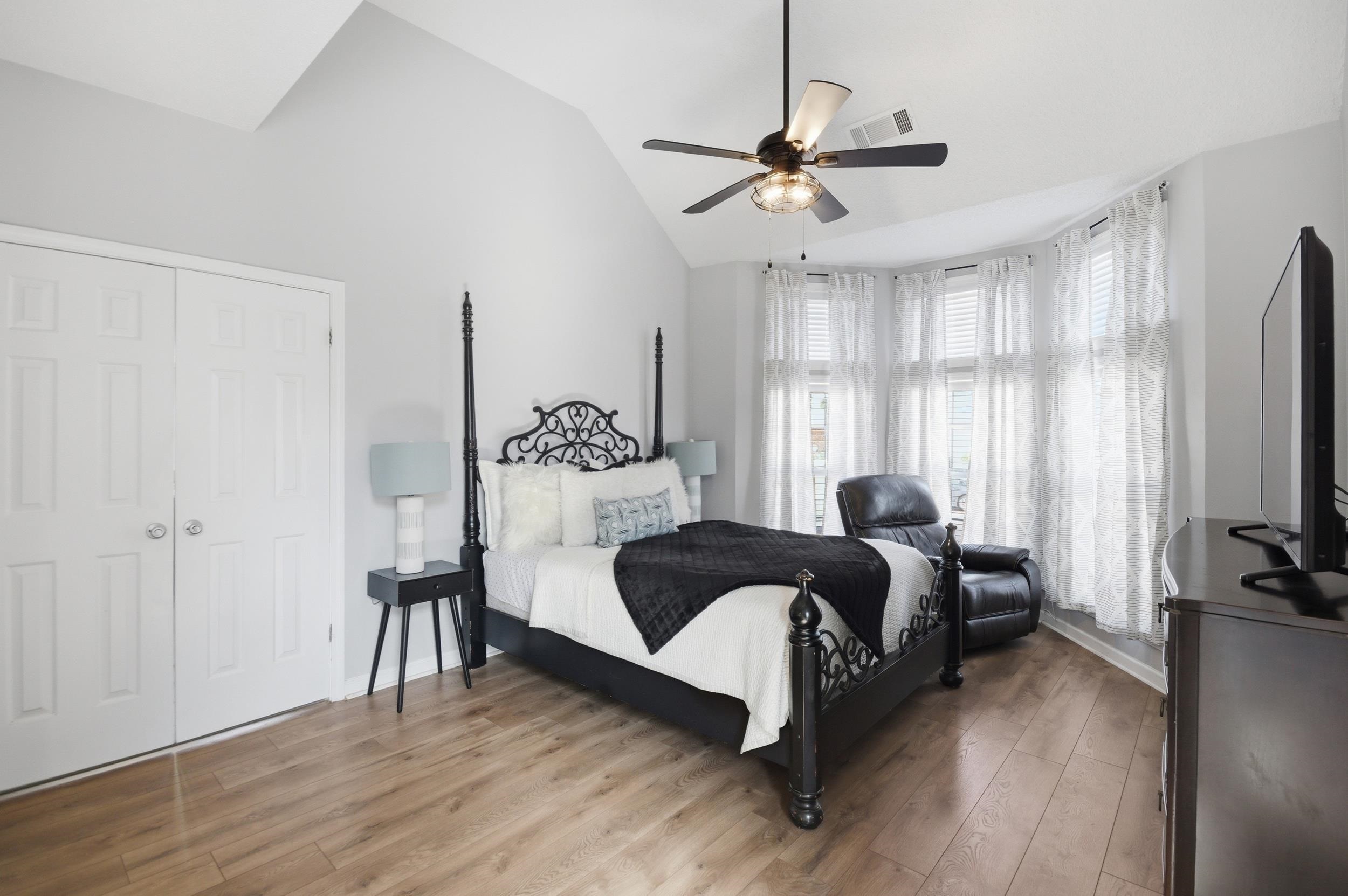 6605 Stephan Ridge Cove Bartlett, TN 38135 - Photo 12 of 30 Bedroom featuring light wood finished floors, vaulted ceiling, and a ceiling fan