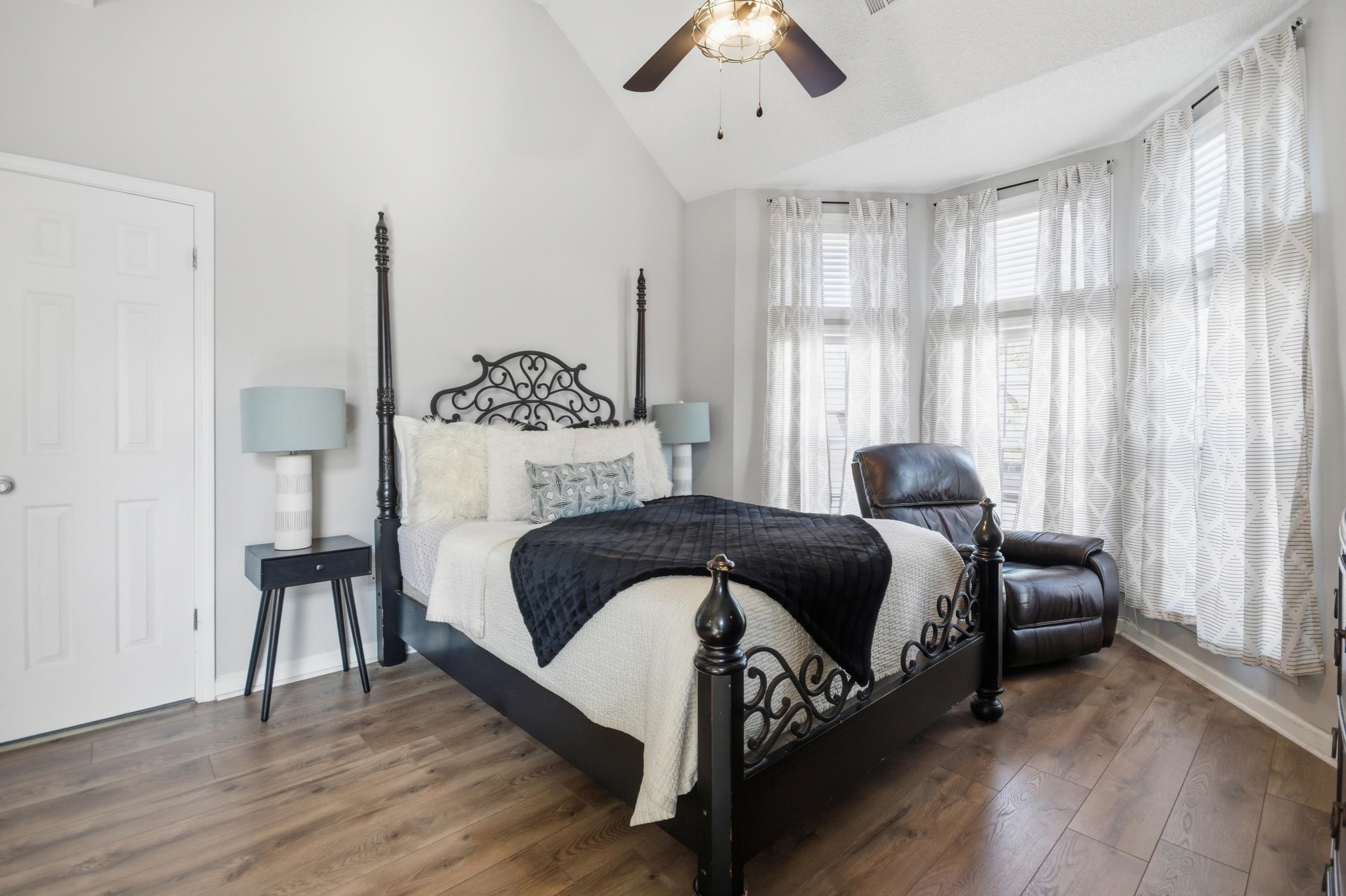 6605 Stephan Ridge Cove Bartlett, TN 38135 - Photo 13 of 30 Bedroom with dark wood-style flooring, lofted ceiling, and ceiling fan