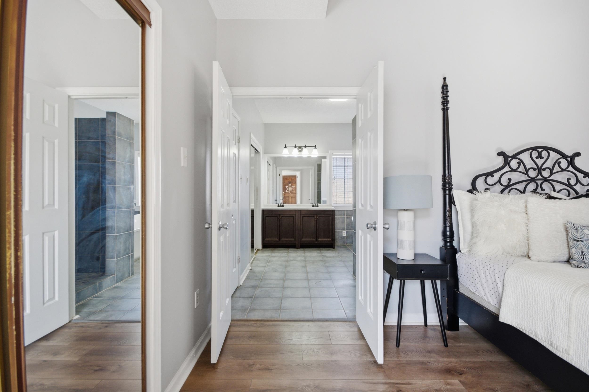 6605 Stephan Ridge Cove Bartlett, TN 38135 - Photo 16 of 30 Bedroom with connected bathroom and dark wood-type flooring