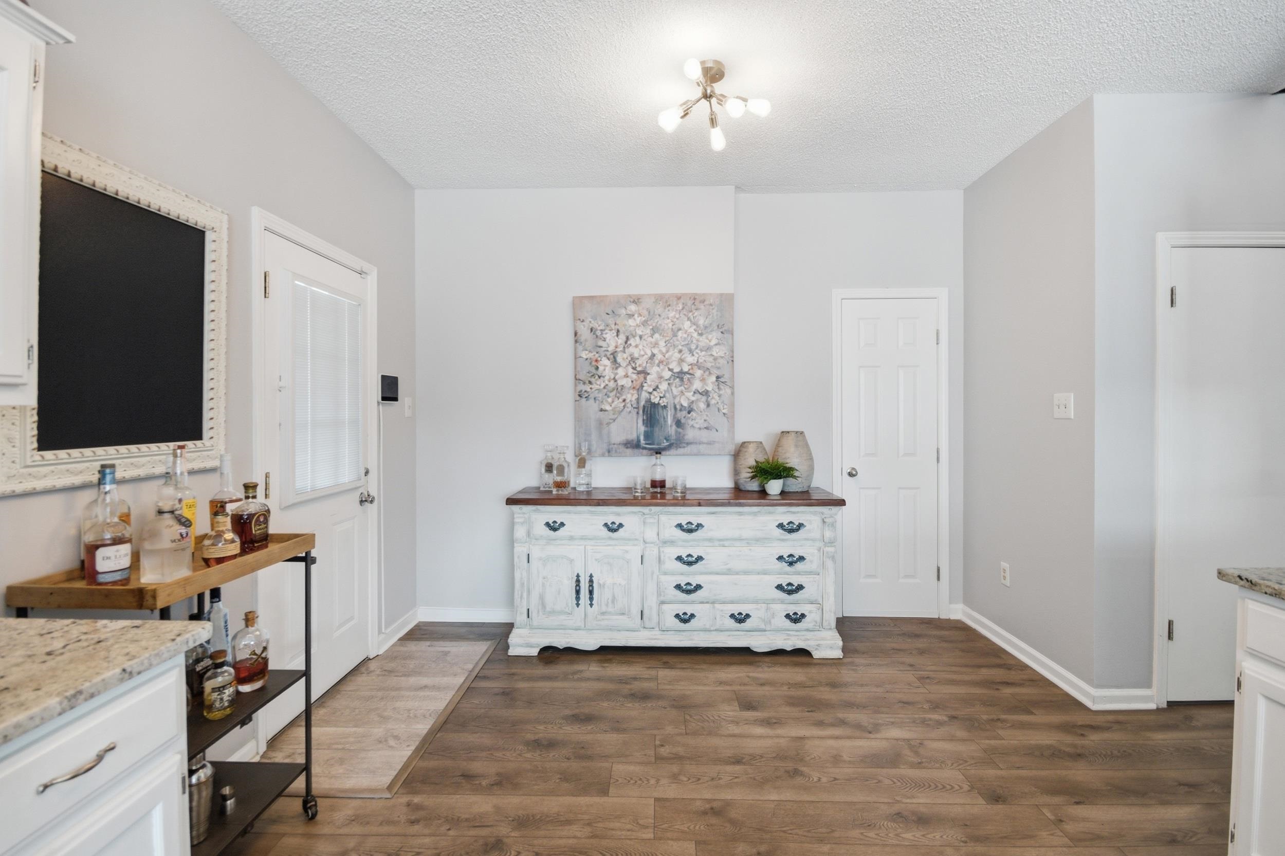 6605 Stephan Ridge Cove Bartlett, TN 38135 - Photo 18 of 30 Dining room featuring dark wood-style floors and a textured ceiling