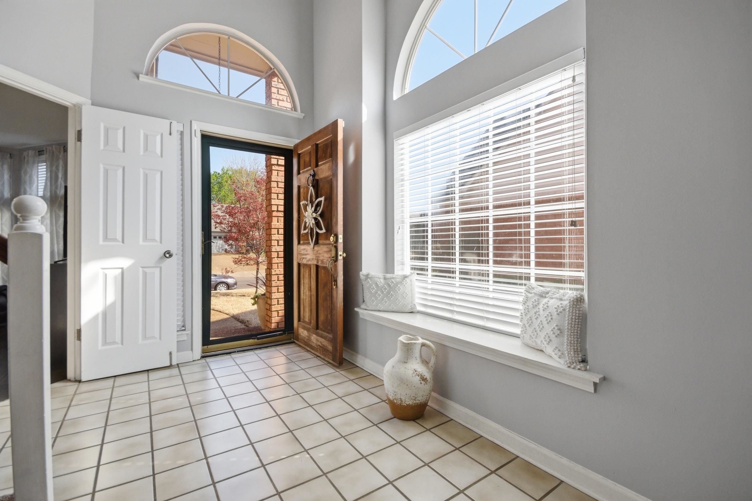 6605 Stephan Ridge Cove Bartlett, TN 38135 - Photo 2 of 30 Entryway featuring light tile patterned floors, plenty of natural light, and a high ceiling