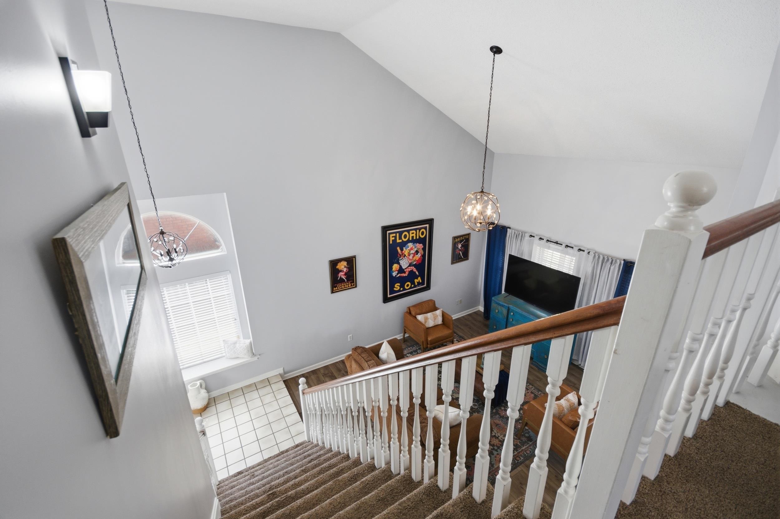 6605 Stephan Ridge Cove Bartlett, TN 38135 - Photo 21 of 30 Staircase featuring a chandelier, carpet, and a high ceiling