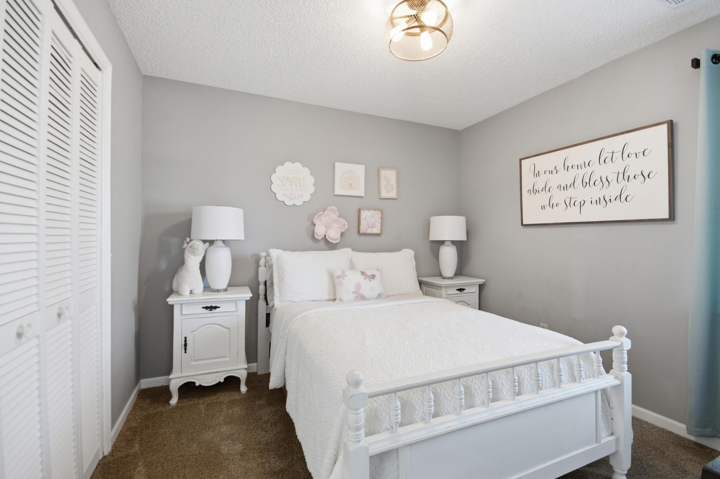 6605 Stephan Ridge Cove Bartlett, TN 38135 - Photo 26 of 30 Bedroom with a closet, dark colored carpet, and a textured ceiling