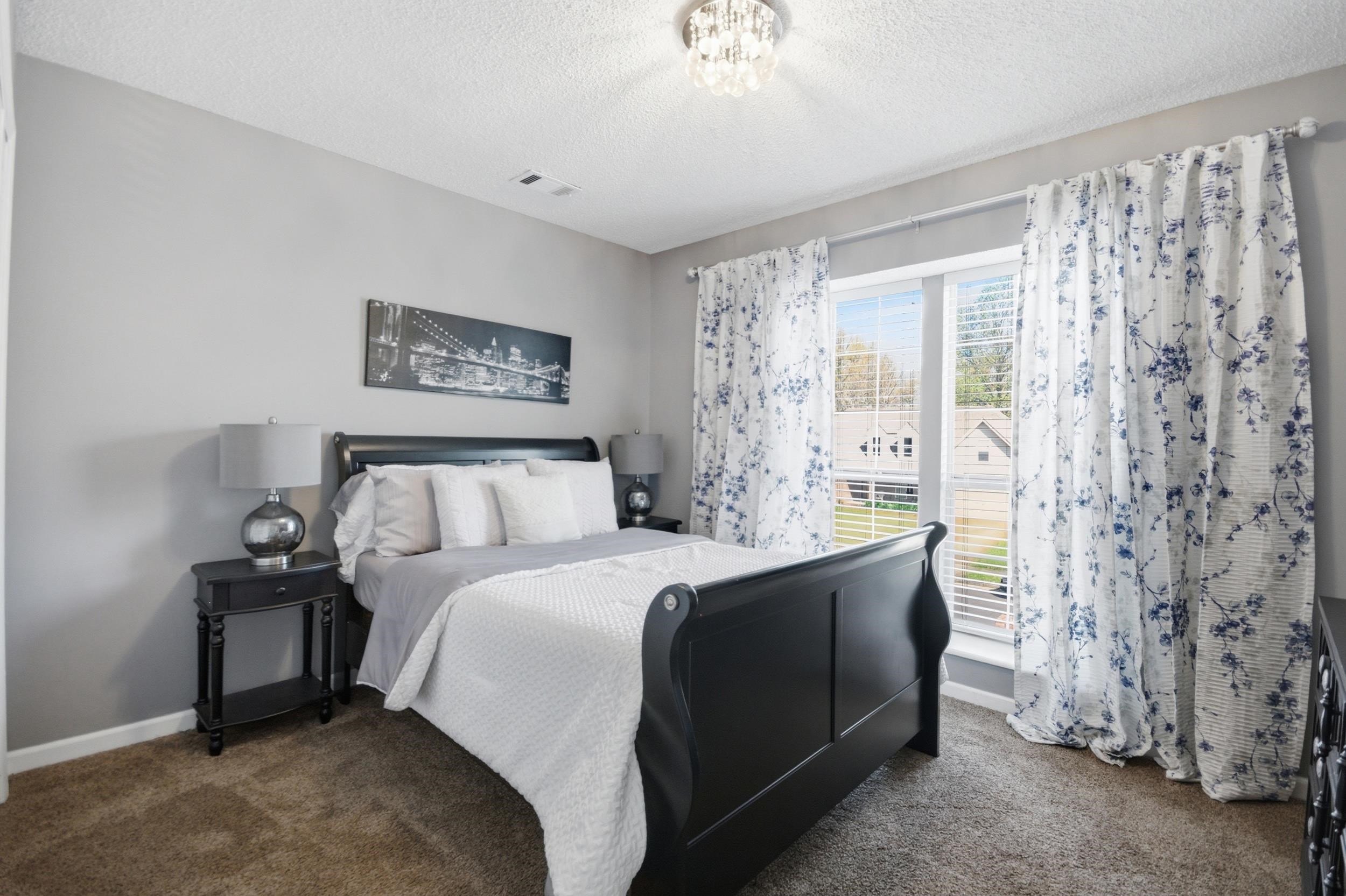 6605 Stephan Ridge Cove Bartlett, TN 38135 - Photo 27 of 30 Bedroom with dark carpet, a textured ceiling, and hanging lights