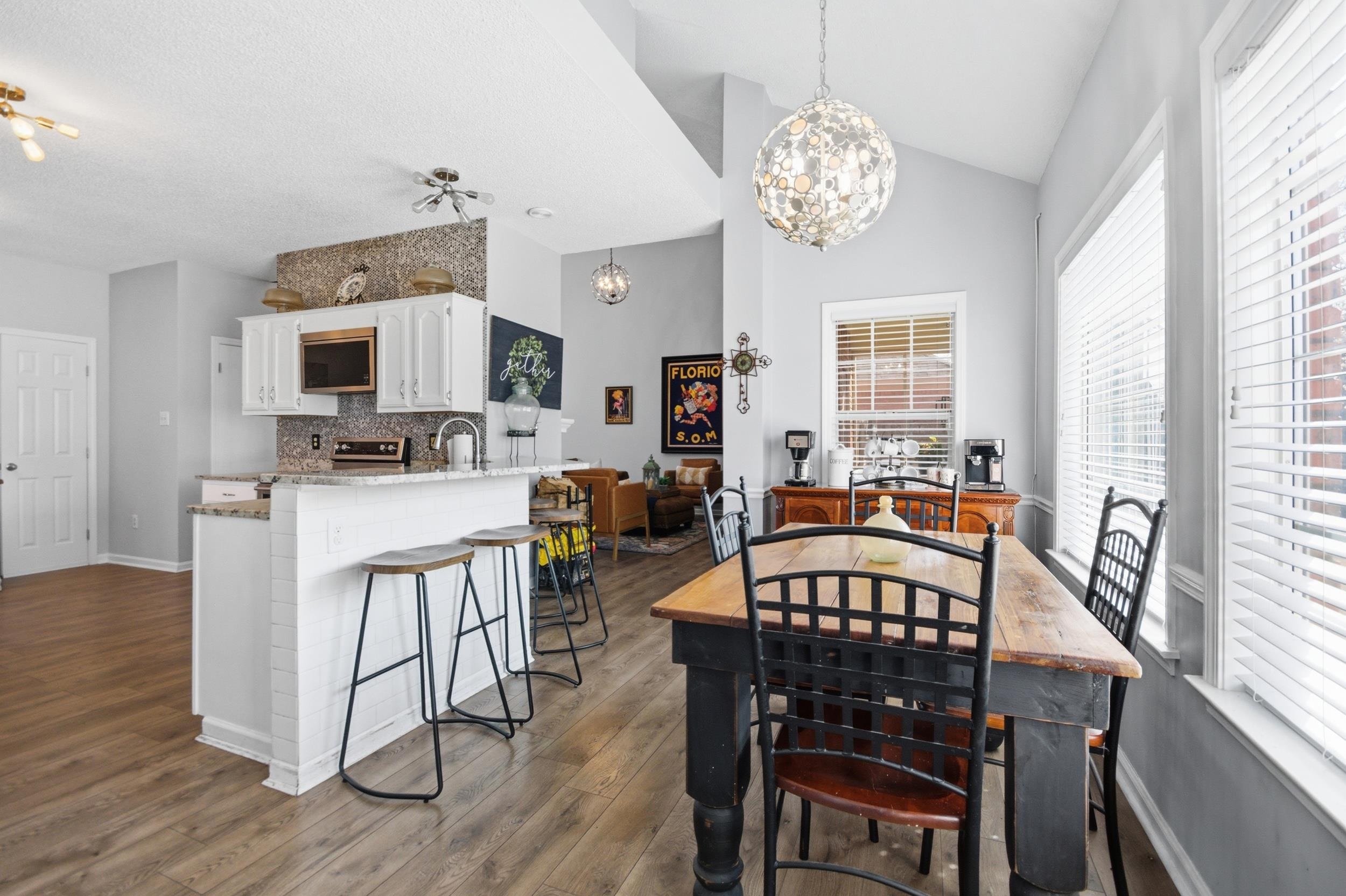6605 Stephan Ridge Cove Bartlett, TN 38135 - Photo 7 of 30 Dining space with dark wood-style flooring, a chandelier, and vaulted ceiling