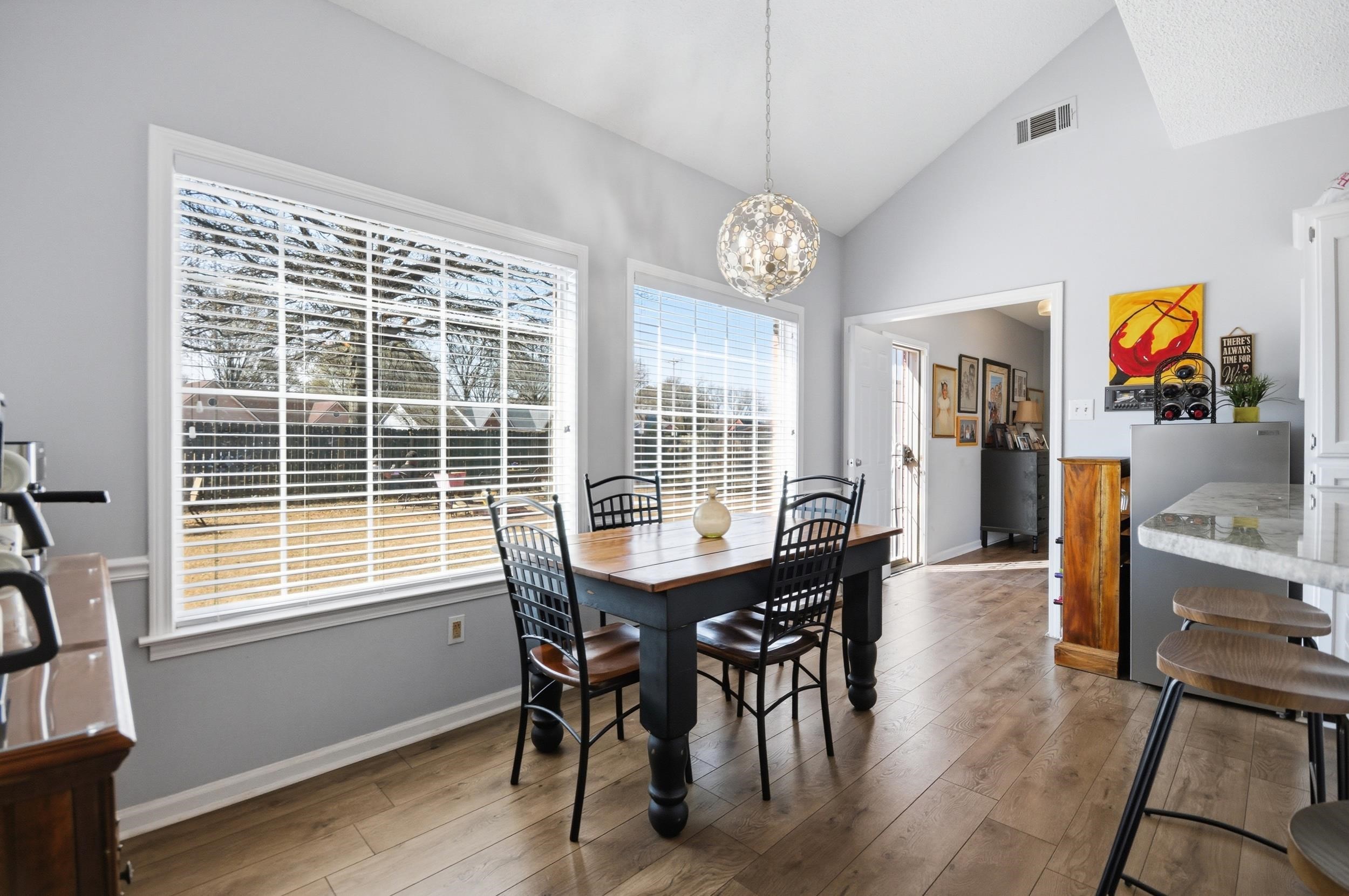 6605 Stephan Ridge Cove Bartlett, TN 38135 - Photo 8 of 30 Dining area with vaulted ceiling, light wood finished floors, and hanging lights