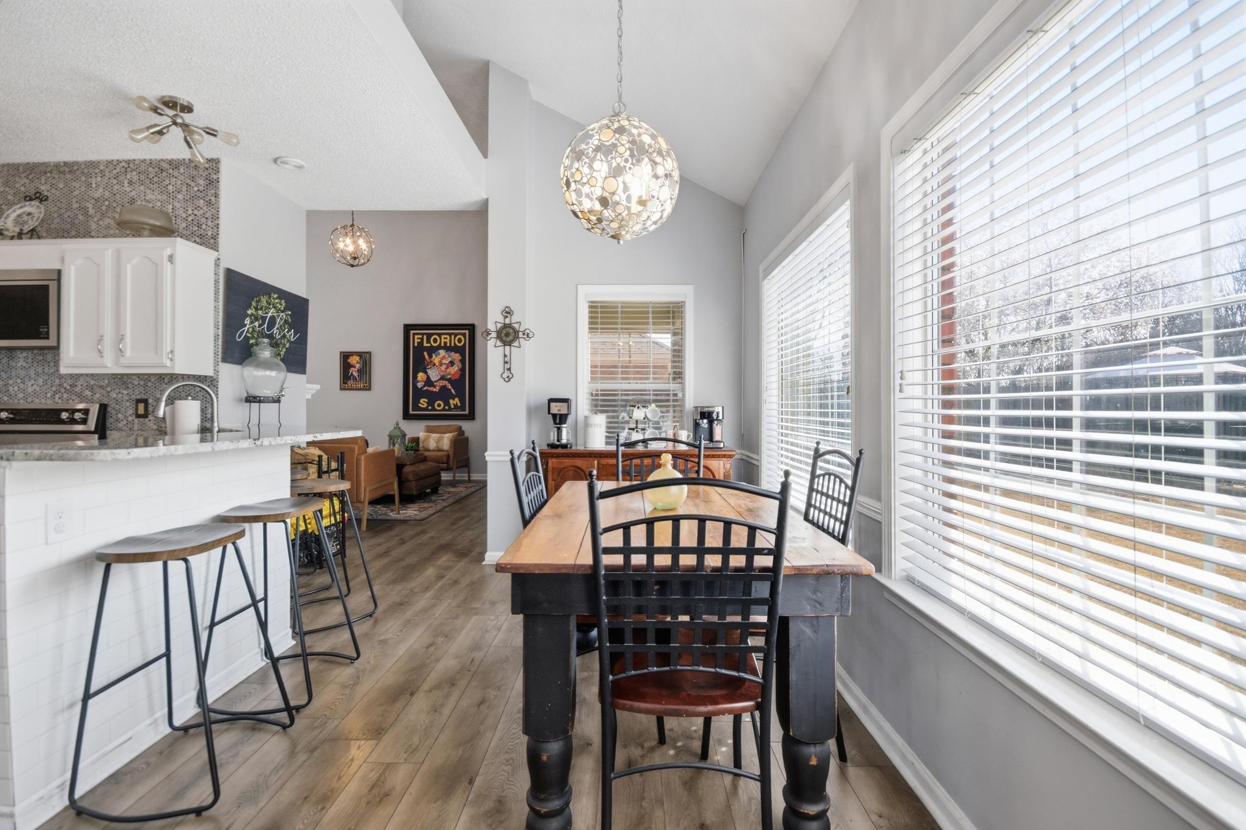 6605 Stephan Ridge Cove Bartlett, TN 38135 - Photo 9 of 30 Dining space with dark wood-type flooring, hanging lights, and lofted ceiling