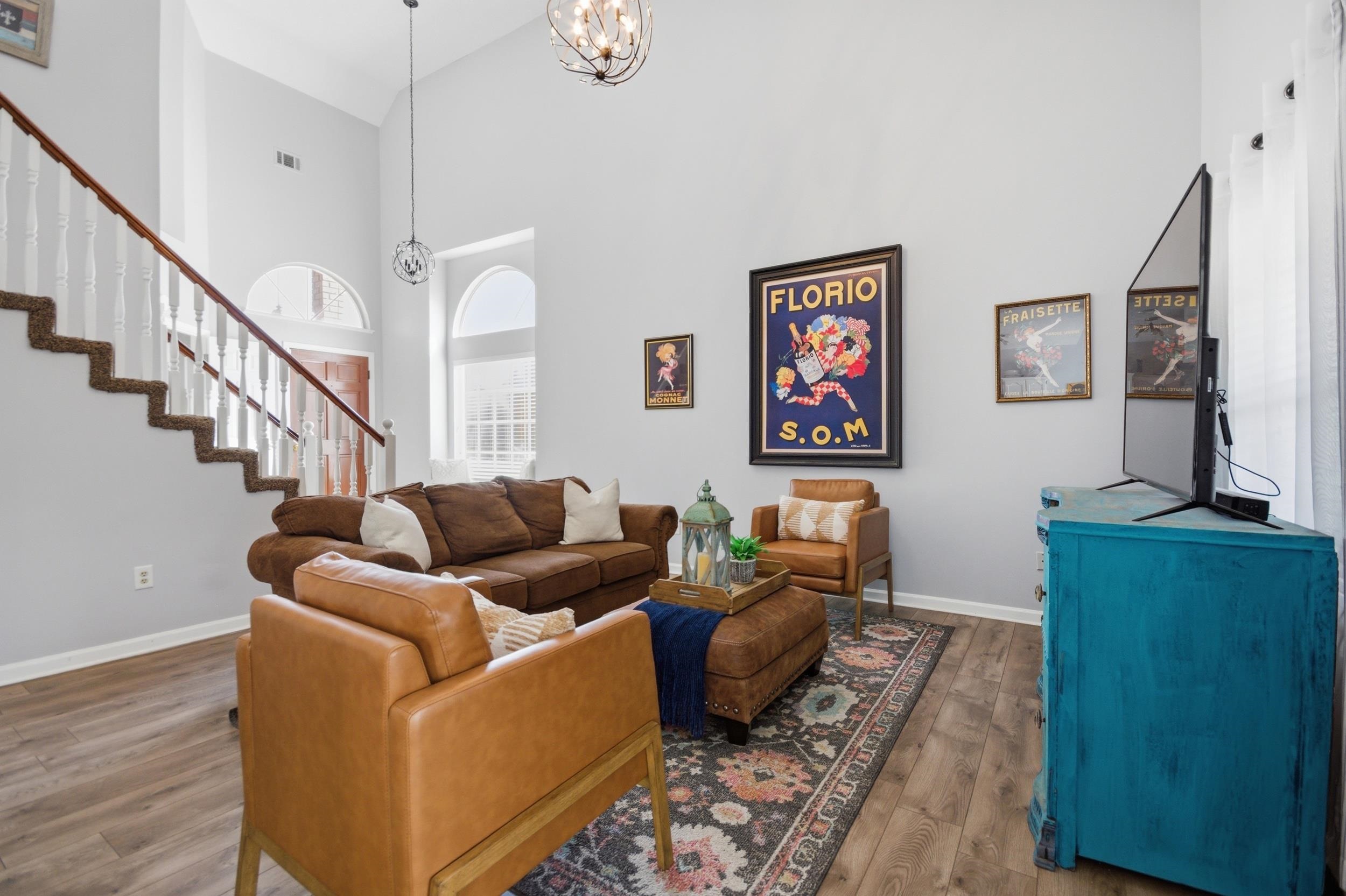 6605 Stephan Ridge Cove Bartlett, TN 38135 - Photo 10 of 30 Living area with wood-type flooring, suspended lighting, and a high ceiling