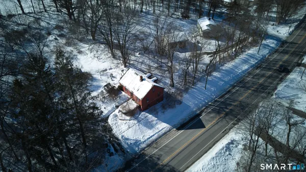 a view of water covered with snow in front of house