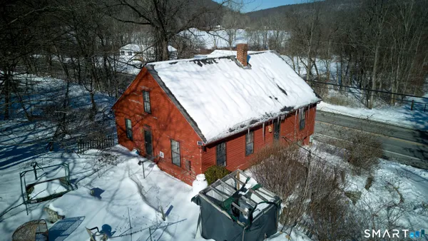 a view of a house with roof deck front of house
