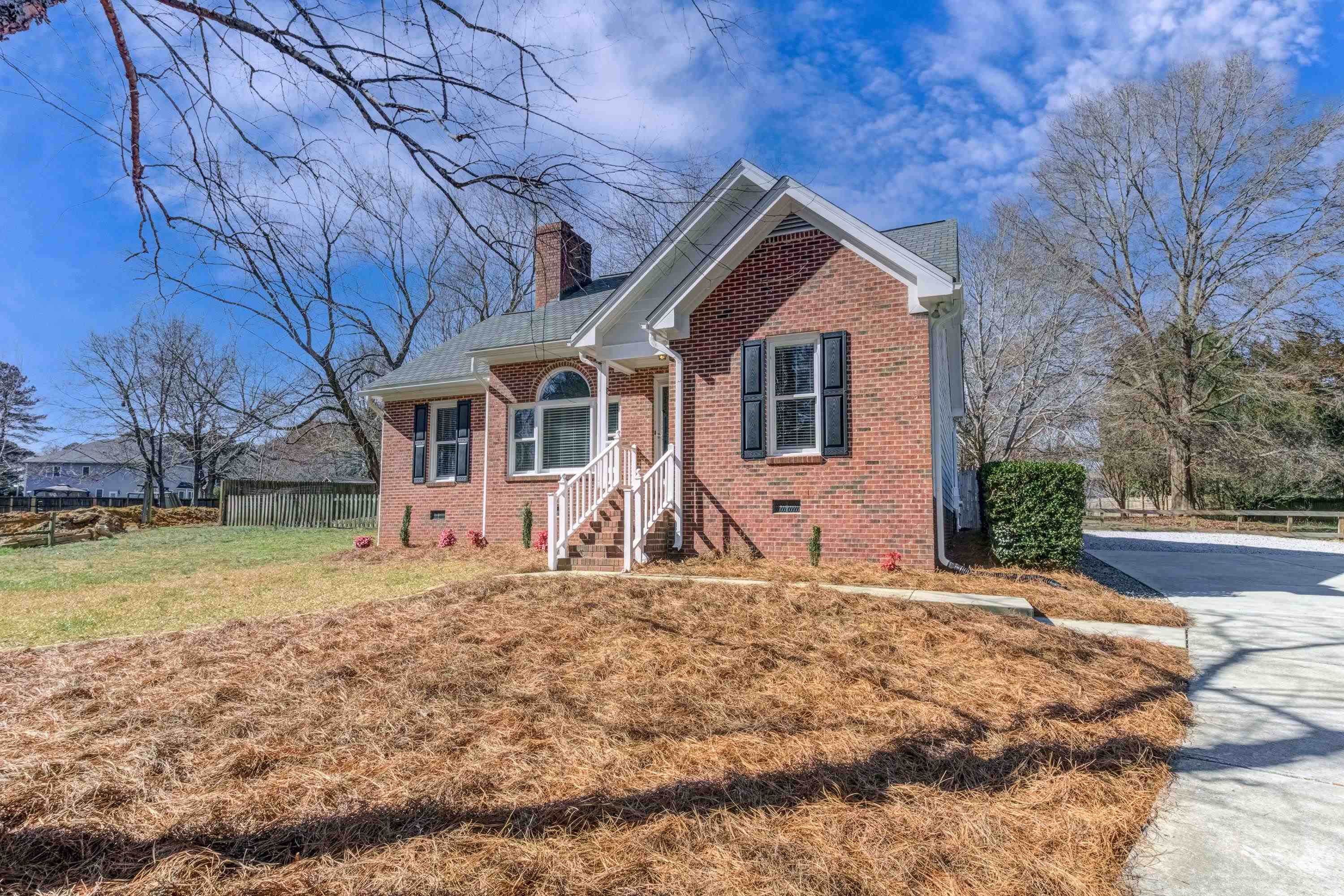 9305 Tallgrass Road Raleigh, NC 27603 - Photo 4 of 49 Nestled at the end of a culdesac you'll find this brick front one story home set back off a long concrete driveway! It's beautiful in the spring when the trees and bushes bloom! Exterior Front