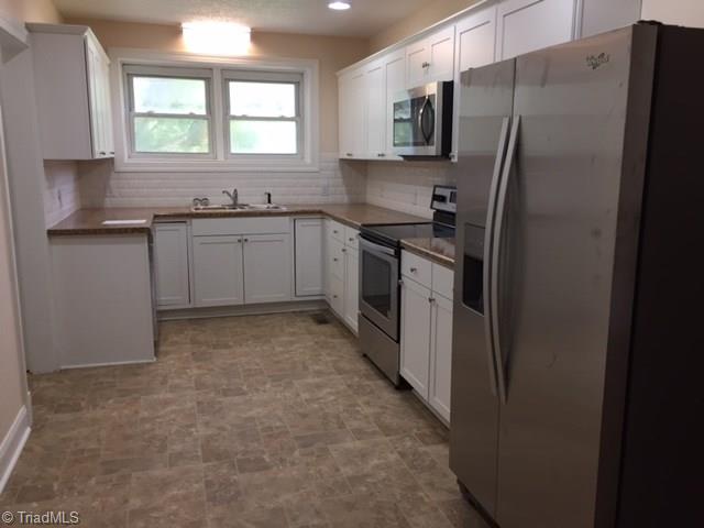 2092 Lick Fork Creek Road Ruffin, NC 27326 - Photo 2 of 10 Updated kitchen wit all new stainless appliances and gorgeous tile backsplash.