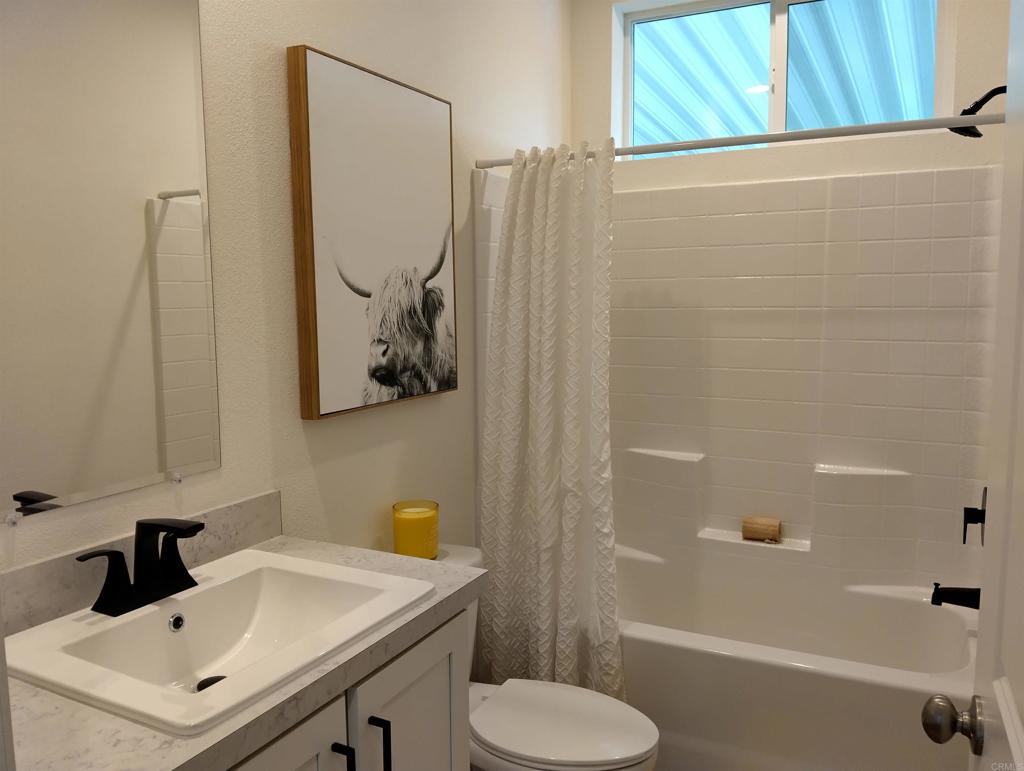 718 Sycamore Avenue, Unit 170 Vista, CA 92083 - Photo 10 of 22 a bathroom with a sink toilet and shower
