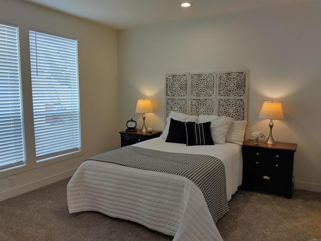 718 Sycamore Avenue, Unit 170 Vista, CA 92083 - Photo 14 of 22 a bedroom with a bed and a window
