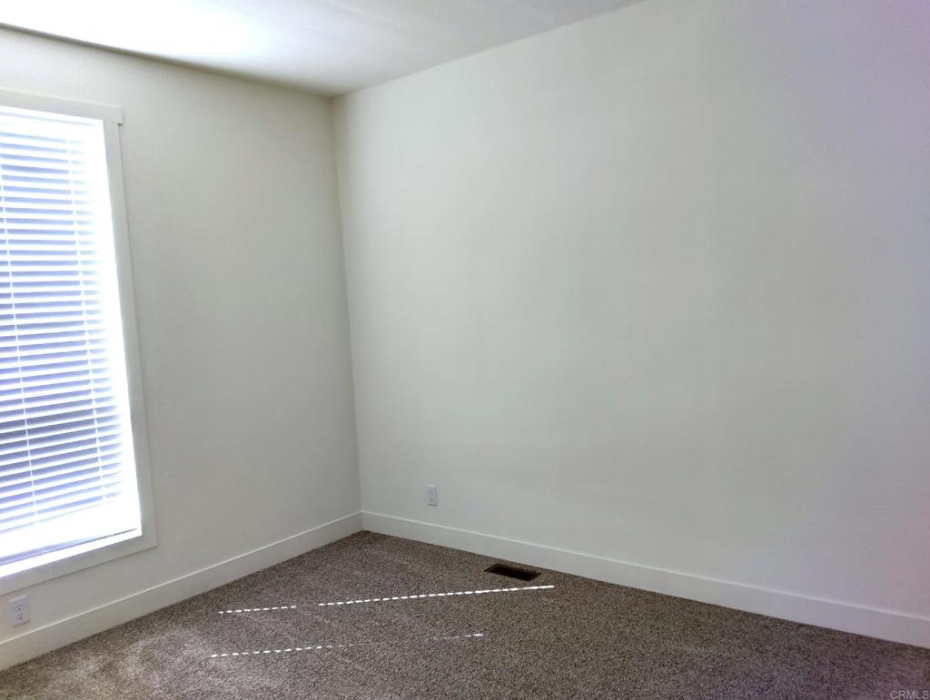 718 Sycamore Avenue, Unit 170 Vista, CA 92083 - Photo 17 of 22 an empty room with a window