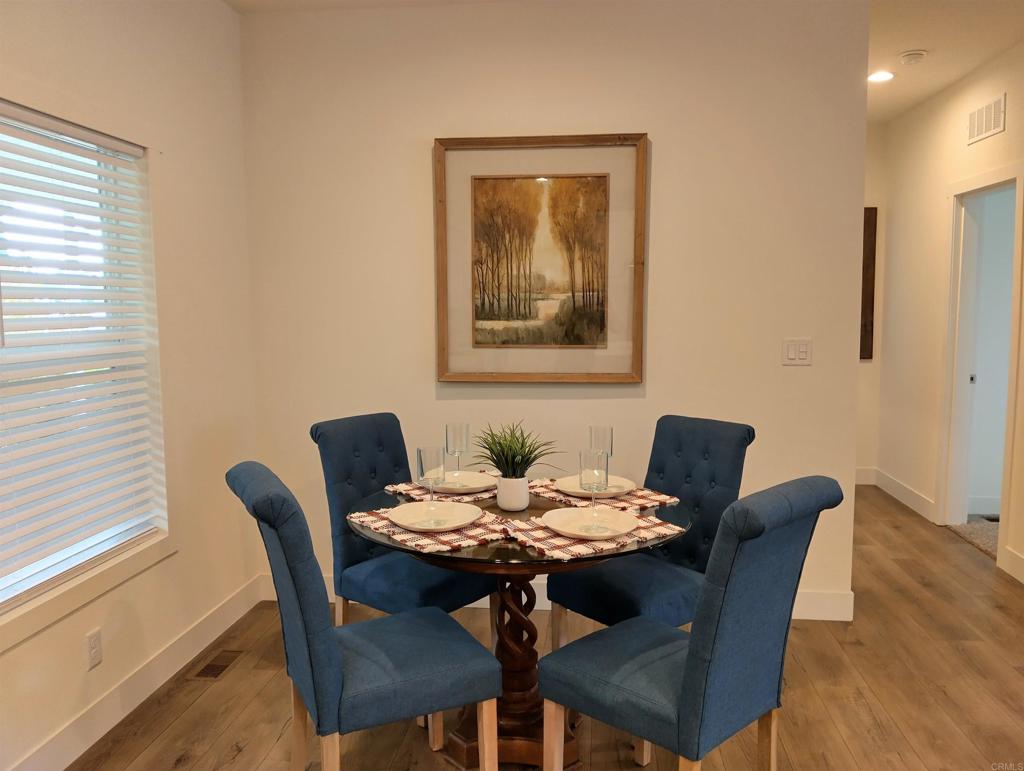 718 Sycamore Avenue, Unit 170 Vista, CA 92083 - Photo 6 of 22 a view of a dining room with furniture and wooden floor