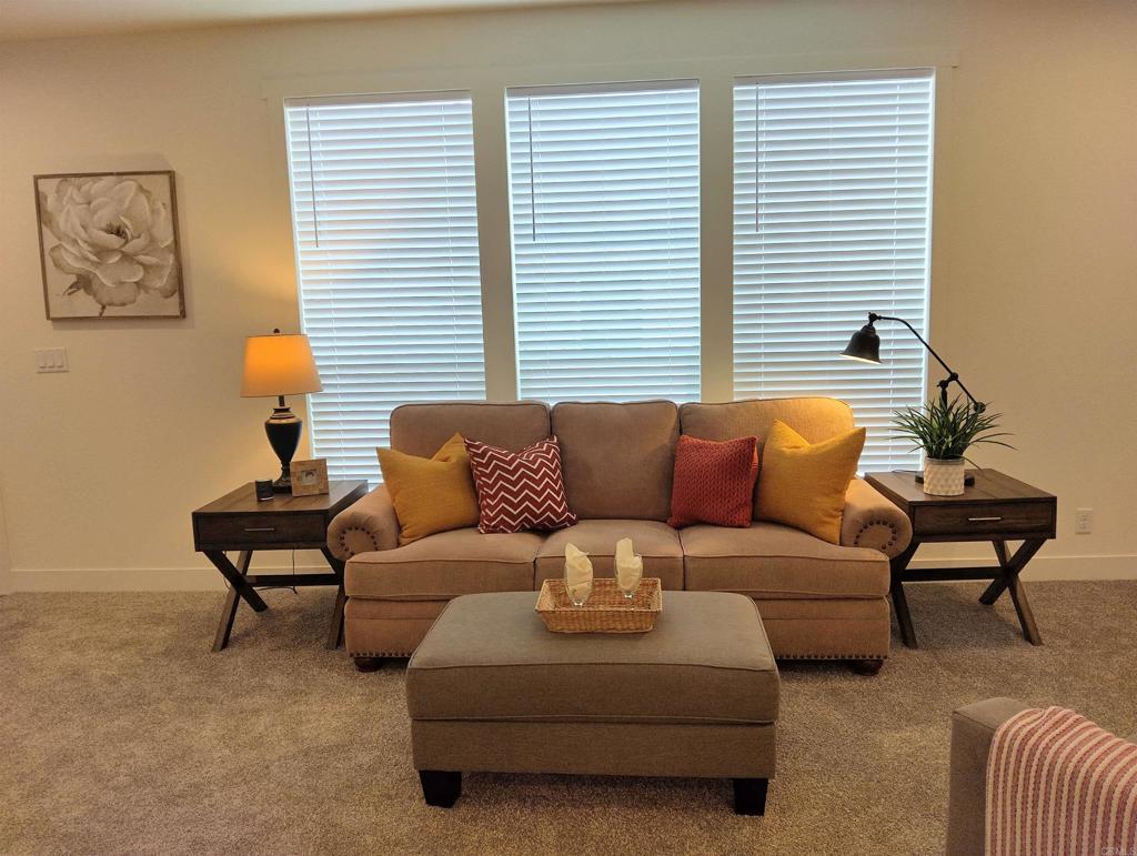 718 Sycamore Avenue, Unit 170 Vista, CA 92083 - Photo 8 of 22 a living room with furniture and a window
