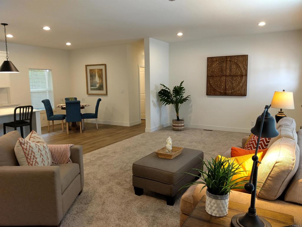 718 Sycamore Avenue, Unit 170 Vista, CA 92083 - Photo 22 of 22 a living room with furniture and a potted plant
