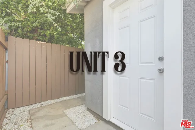 a kitchen with stainless steel appliances granite countertop a stove top oven a sink and a refrigerator