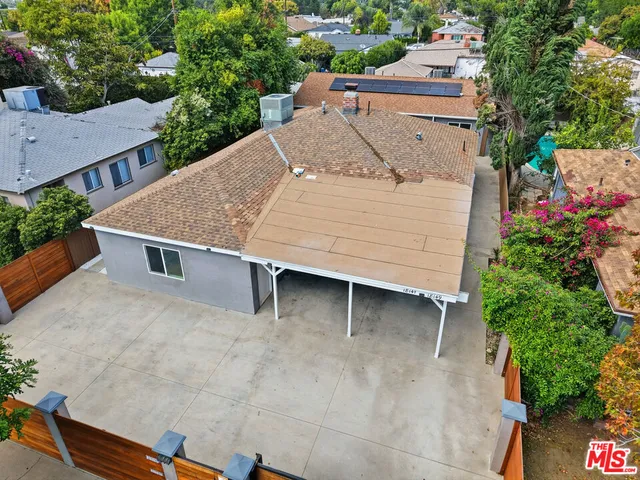 an aerial view of a house with a yard and garage