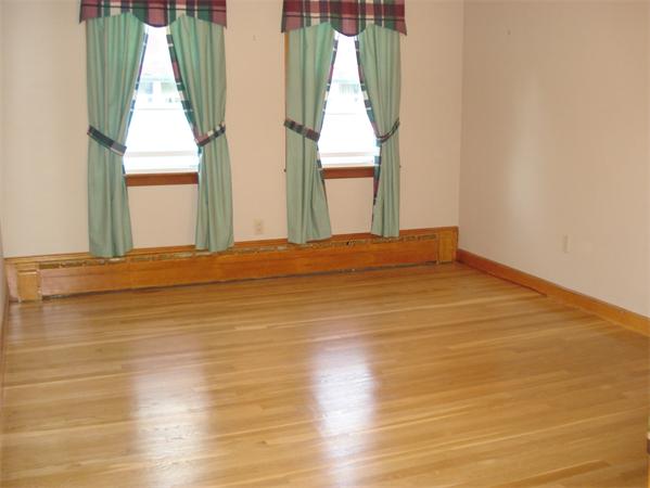 8 Langley Road Arlington, MA 02474 - Photo 8 of 17 a view of empty room with wooden floor and fan