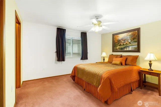 an empty room with closet and a chandelier fan