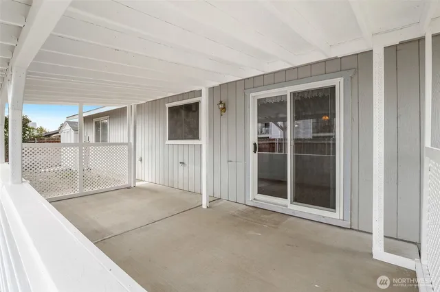 a picture of a room with a white refrigerator and white walls
