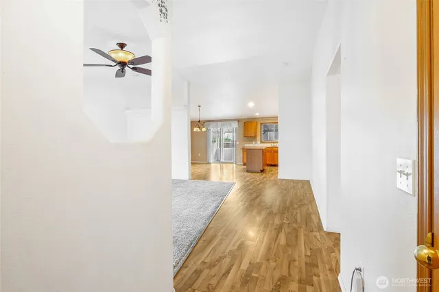 a view of a bedroom with wooden floor and windows