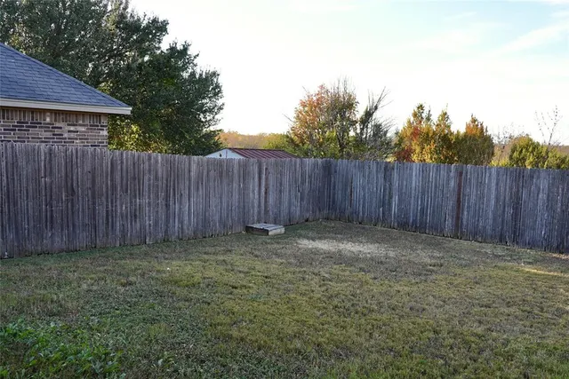 a view of outdoor space with wooden fence