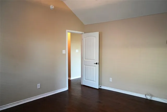 an empty room with wooden floor