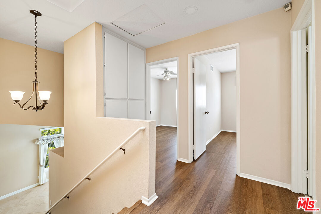 27050 Riversbridge Way Valencia, CA 91354 - Photo 12 of 37 a view of a hallway with wooden floor