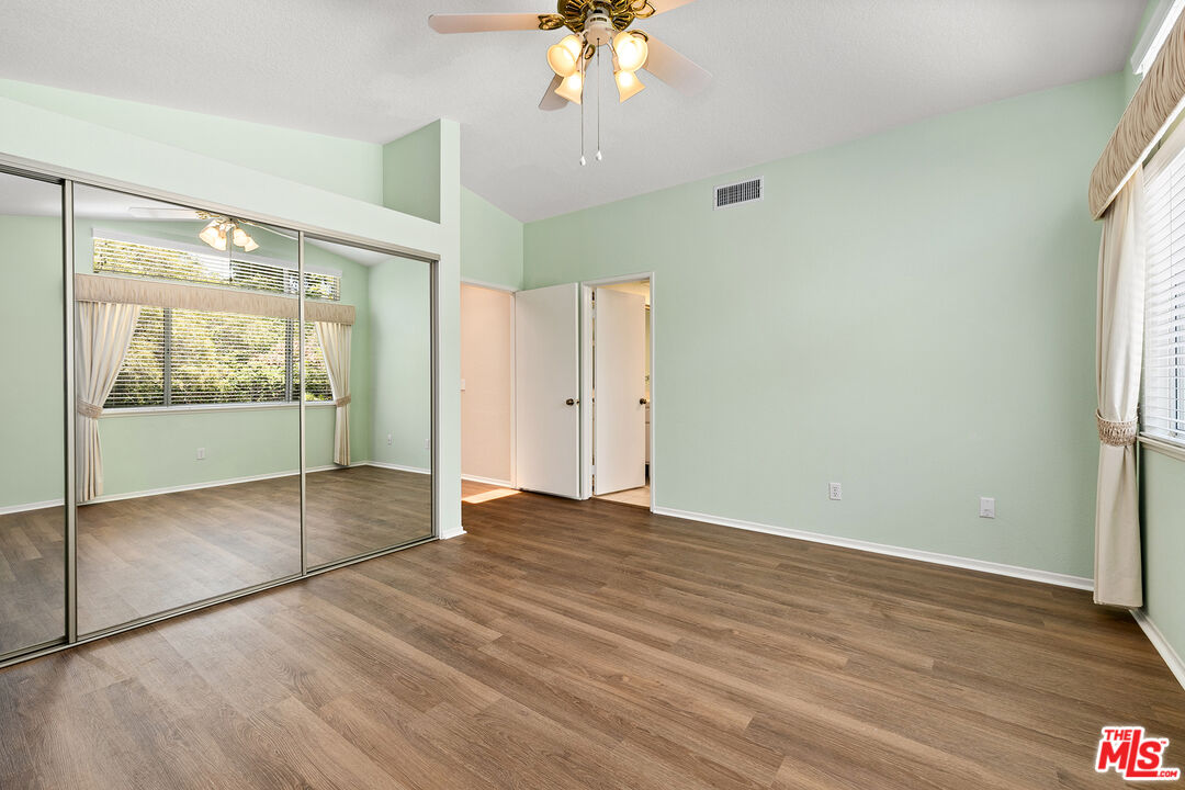 27050 Riversbridge Way Valencia, CA 91354 - Photo 14 of 37 a view of an empty room with window and wooden floor