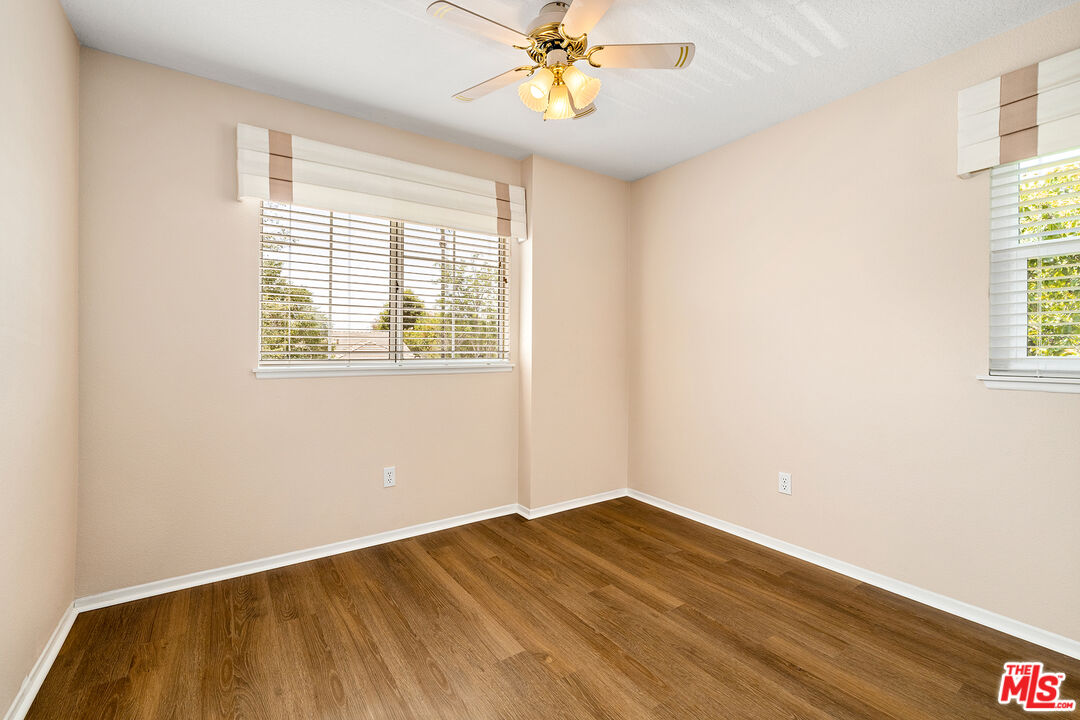27050 Riversbridge Way Valencia, CA 91354 - Photo 17 of 37 wooden floor in an empty room with a window